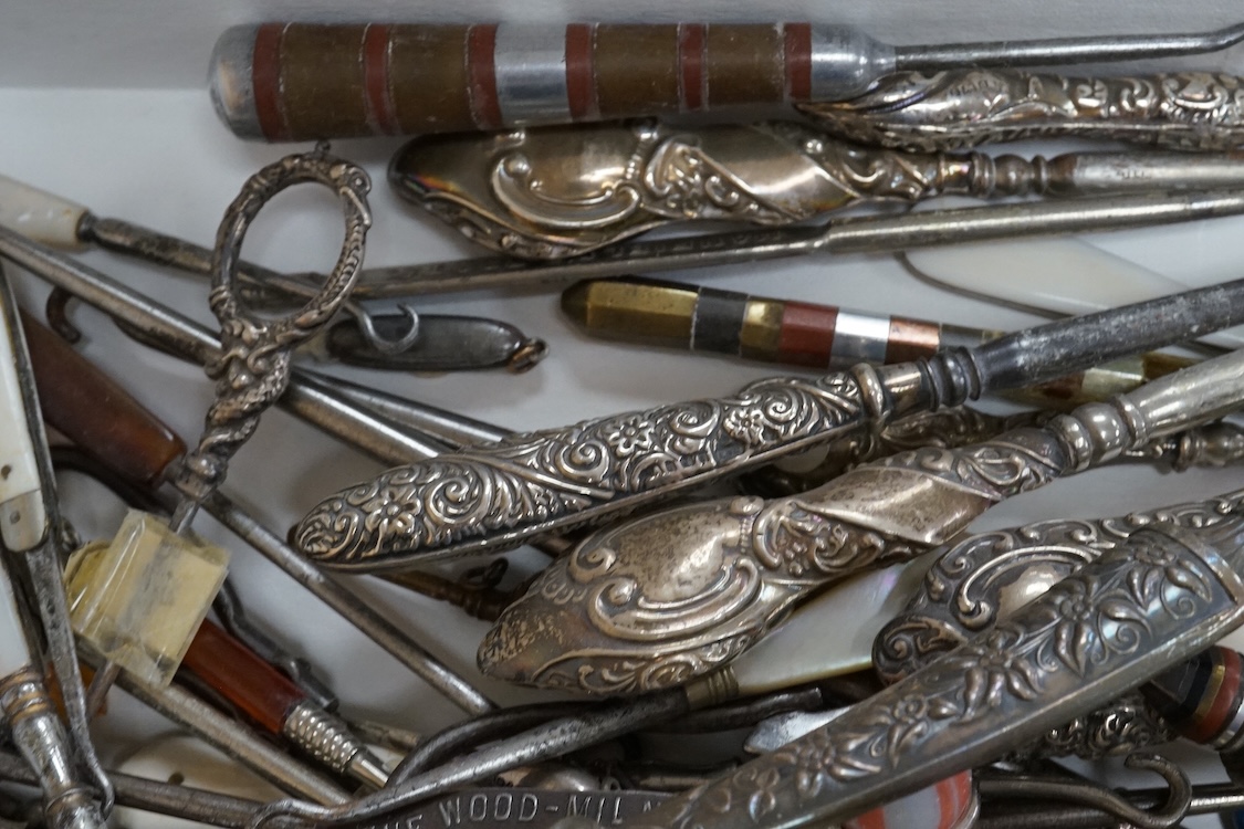 A large collection of Victorian button hooks, with silver, plate, mother of pearl and other handles